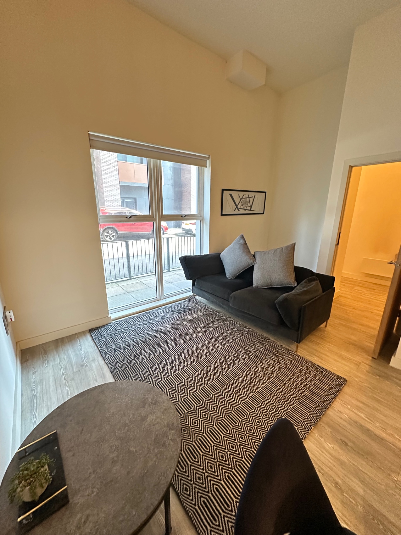 MiddleWood Plaza — living room with sofa and street-facing window