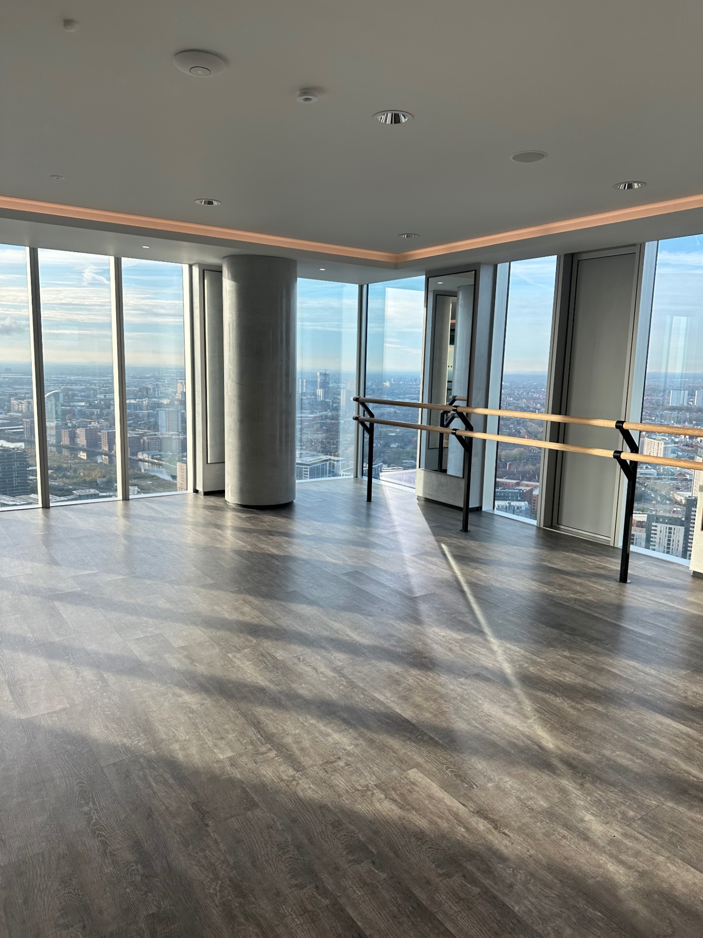 Elizabeth Tower residents’ yoga and barre studio with floor-to-ceiling windows and city views