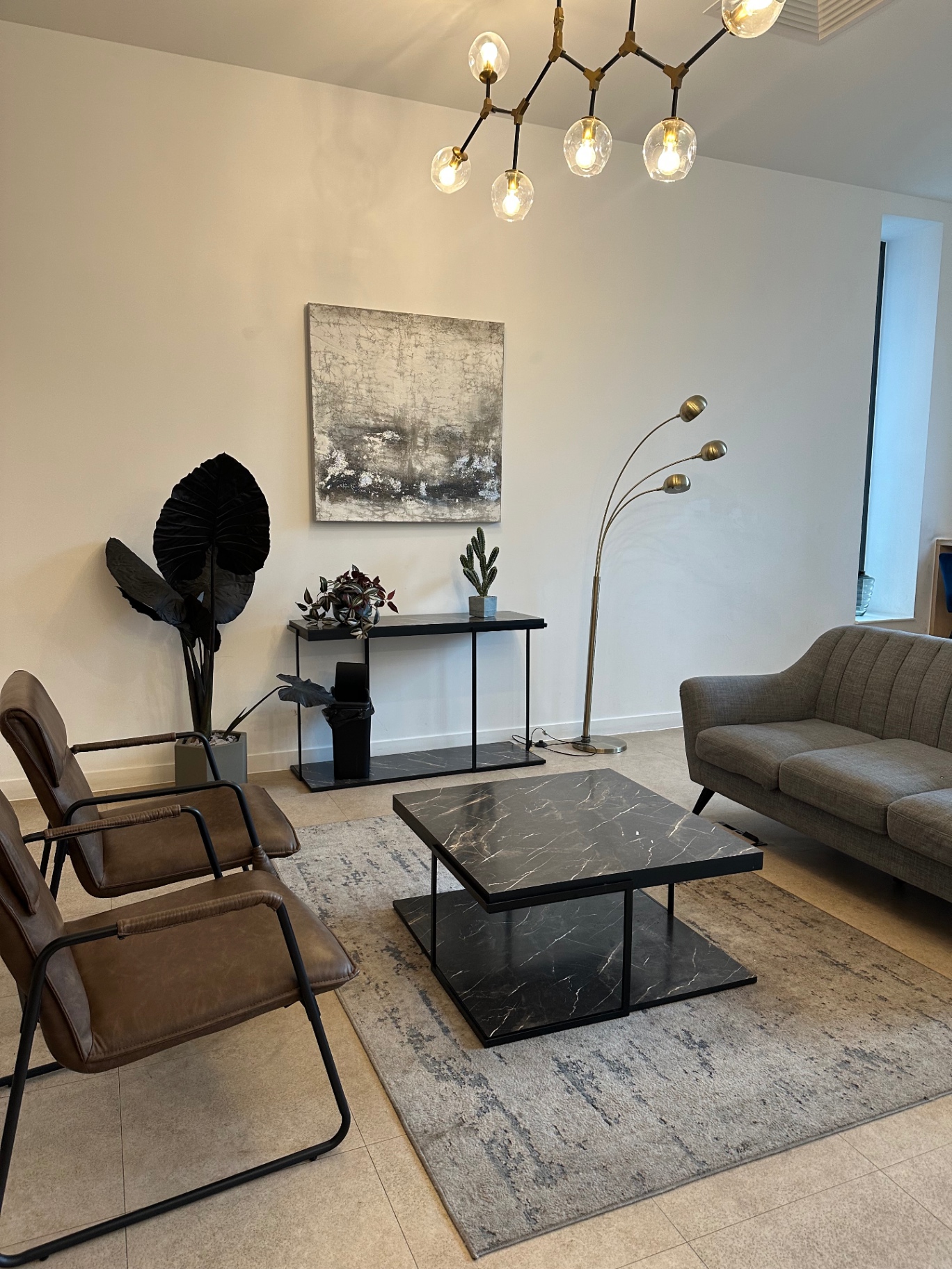 Fifty5ive residents’ lounge with leather chairs and abstract art