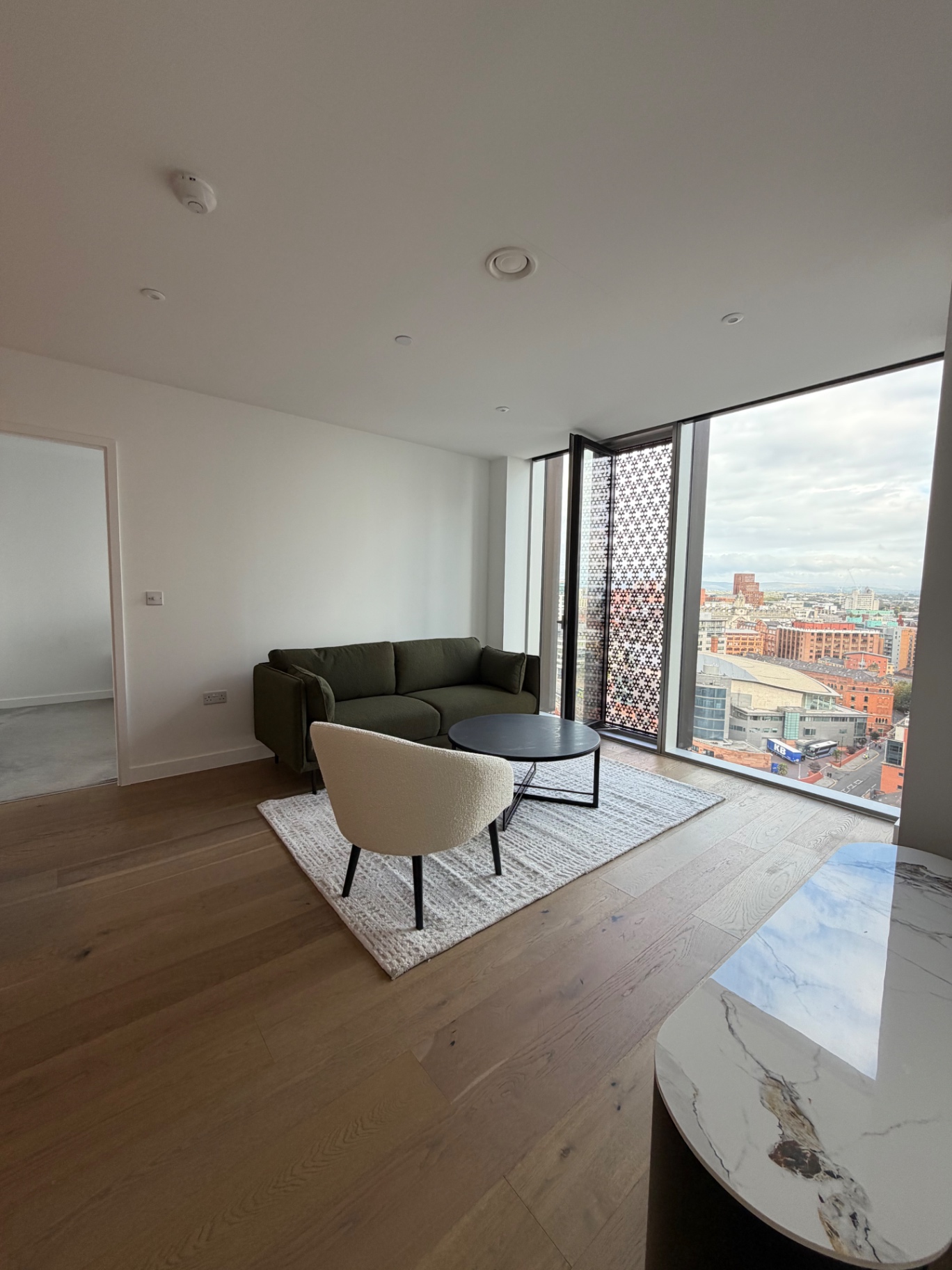 Viadux — open-plan living room with floor-to-ceiling city views